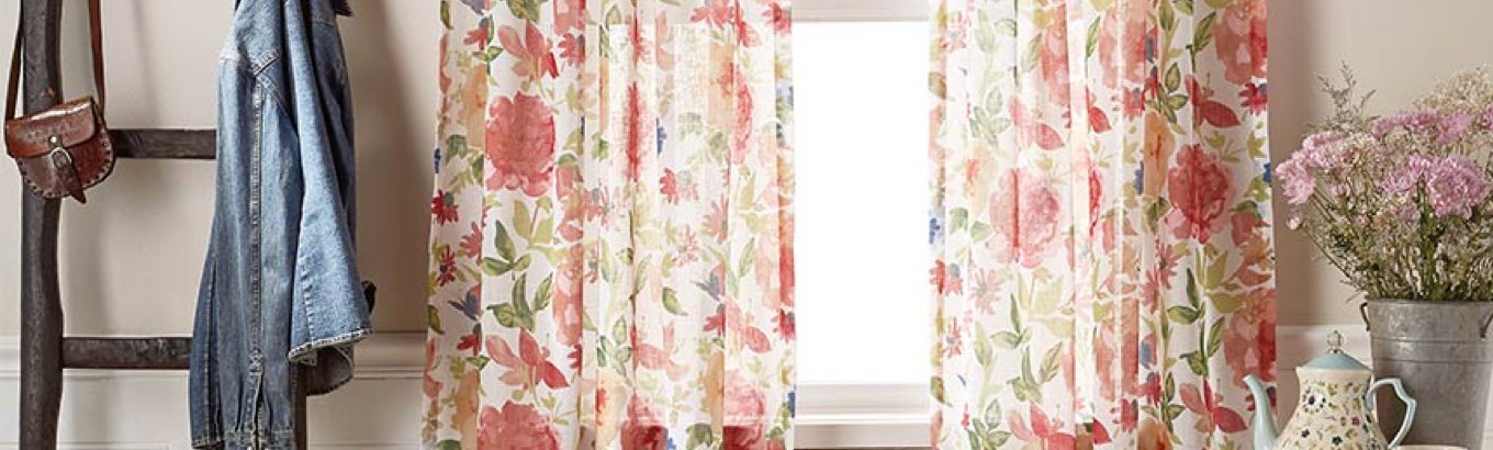 A set of floral curtains in a window. Starts the window treatment ideas blog post on dxoffersmall.com.