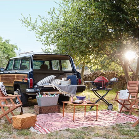 A vintage-style Volkswagon with a tailgating set up including stylish folding chairs, portable grills, and cozy outdoor decor form dxoffersmall.com